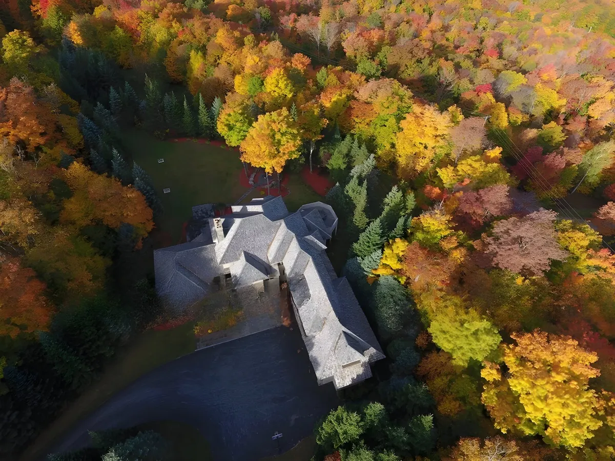 This image presents the house set amidst colorful trees and a manicured lawn, evoking a peaceful, inviting atmosphere perfect for family gatherings. The spacious yard and natural scenery suggest opportunities for outdoor celebrations and group activities, aligning with the section's emphasis on reunions and multi-generational fun.