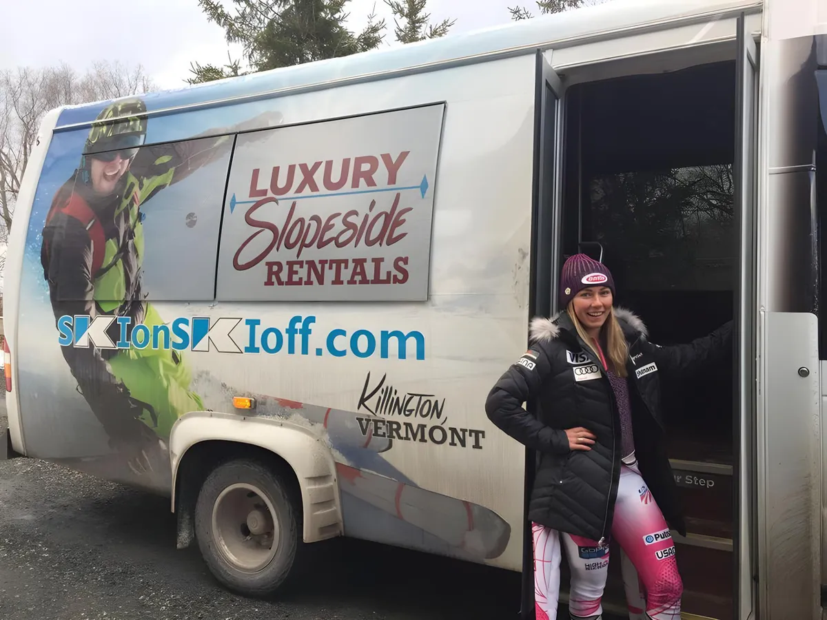 A luxury van, branded for ski rentals, is parked with a female skier preparing for an adventure. The winter landscape and ski gear create a dynamic atmosphere, evoking the excitement of heading to the slopes via private shuttle or after a day’s skiing.